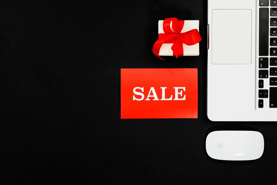 Sale promotional banner and gift boxes showcasing genuine seasonal price reduction strategies