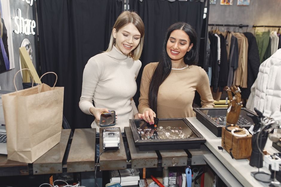 Shopper paying with contactless credit card at store counter taking advantage of instant card discounts