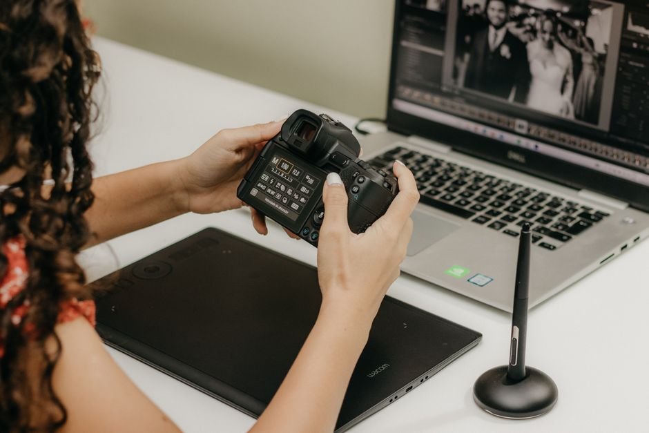 Photographer adjusting fine color tones and contrast curves with precision stylus