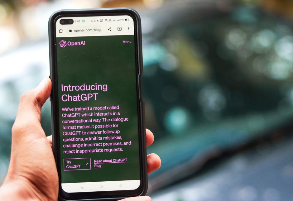 Smartphone displaying generative AI chatbot application in hand