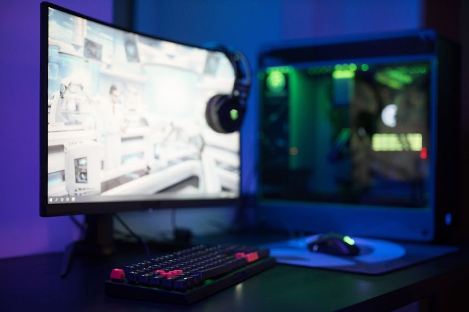 Immersive curved monitor setup with mechanical gaming keyboard and custom PC tower