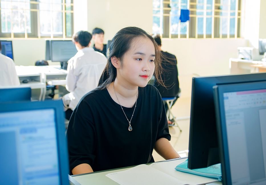 University student reviewing academic research summaries on laptop display
